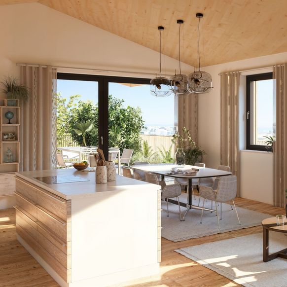 Innenraum Fürstengarten, Kücheninsel mit Esstisch, Couch und Ausgang auf Terrasse